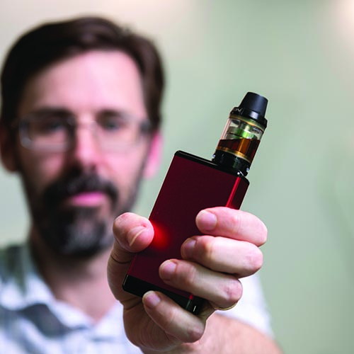 Associate Professor Alex Larcombe holding a vape